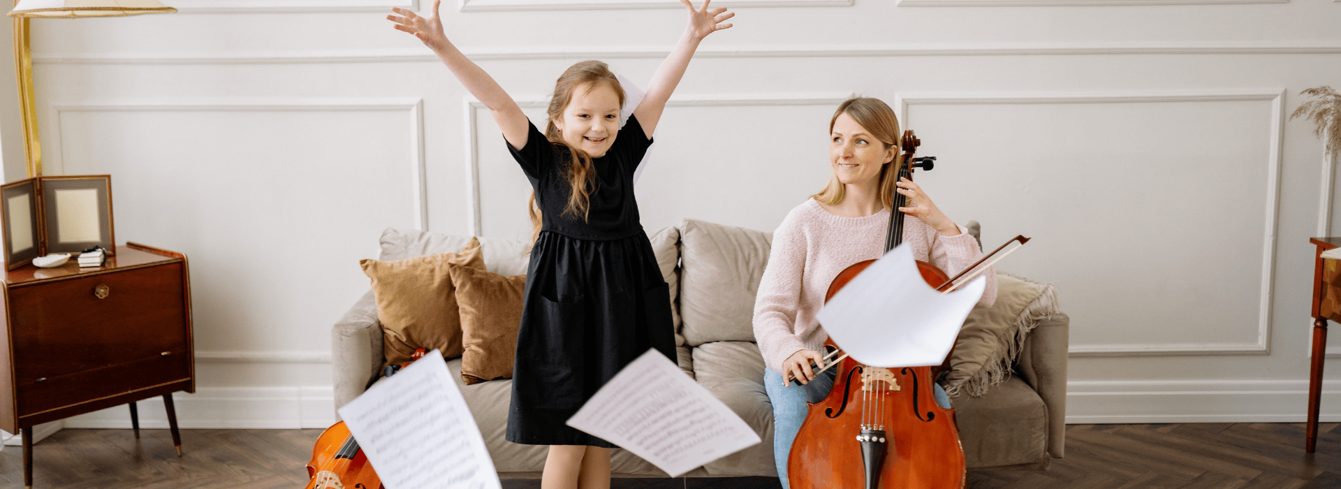 Nanny and girl playing cello together