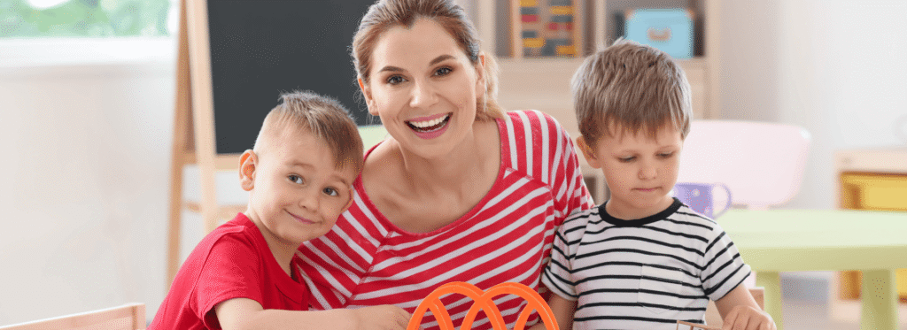 nanny and two children playing