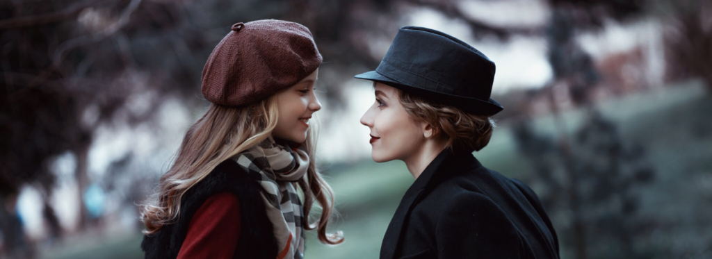 Traditional British Nanny and little girl walk in the Park.