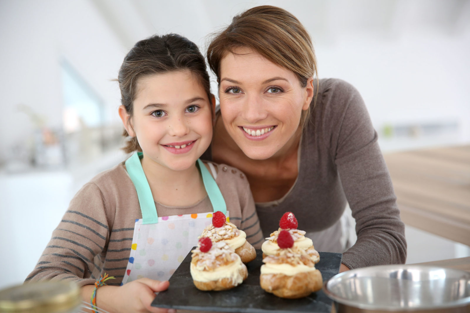 Nanny and girl, brunettes, baking decorative cakes