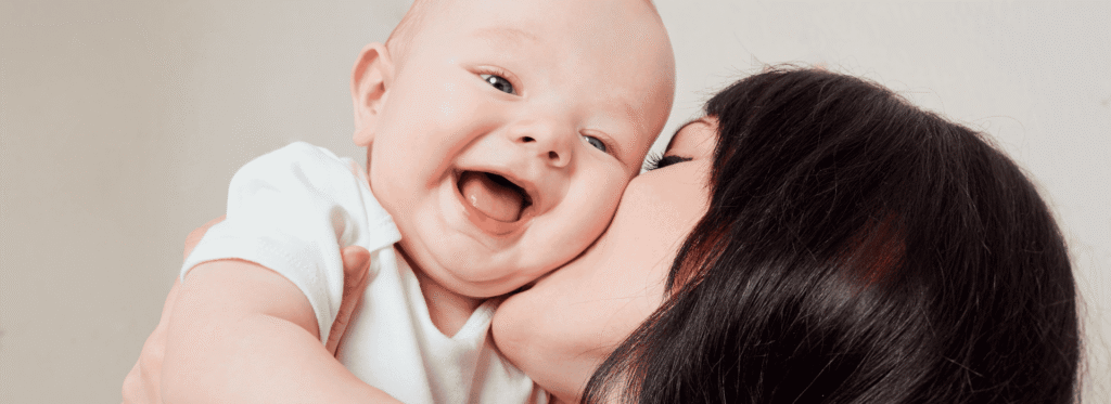 Nanny kissing happy baby