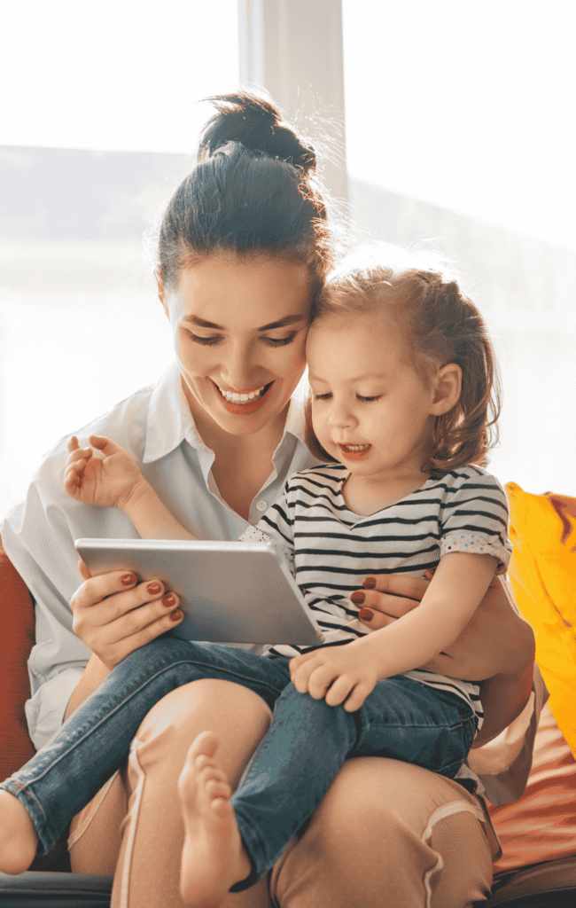 Nanny reading to child on a couch