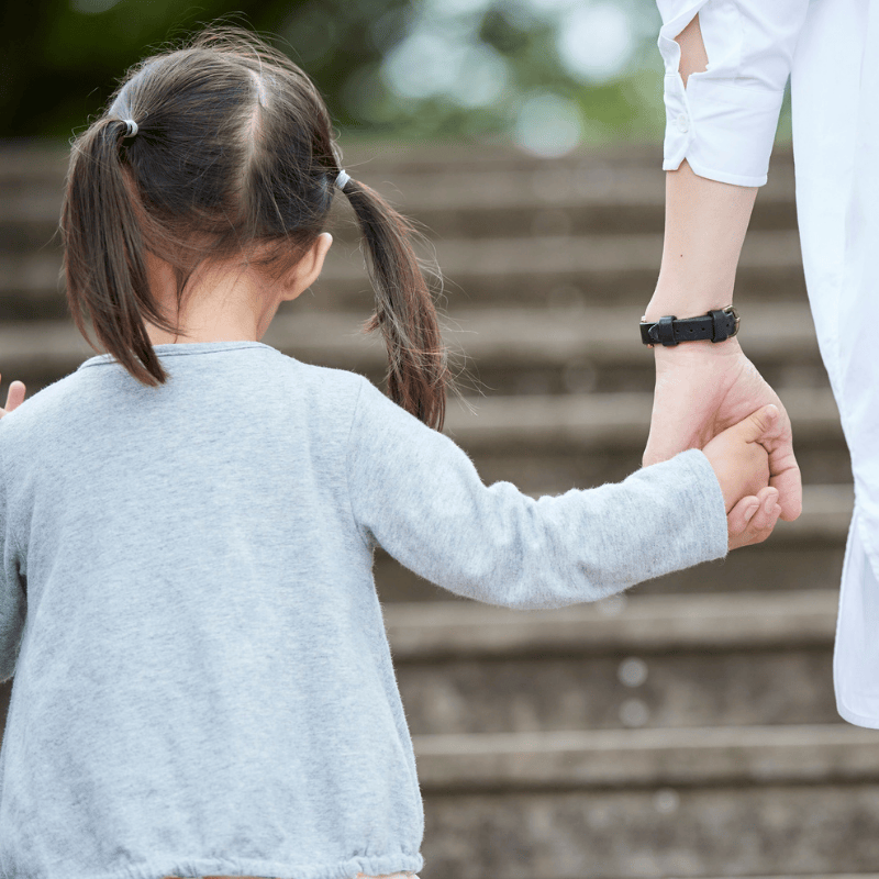 Nanny holding the hand of a child