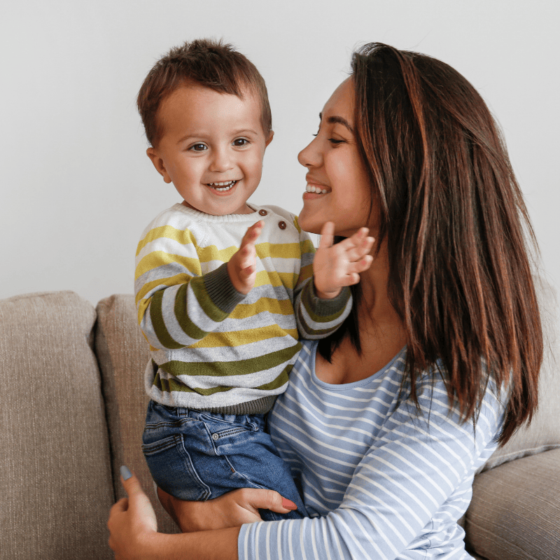 Nanny and child playing on the couch