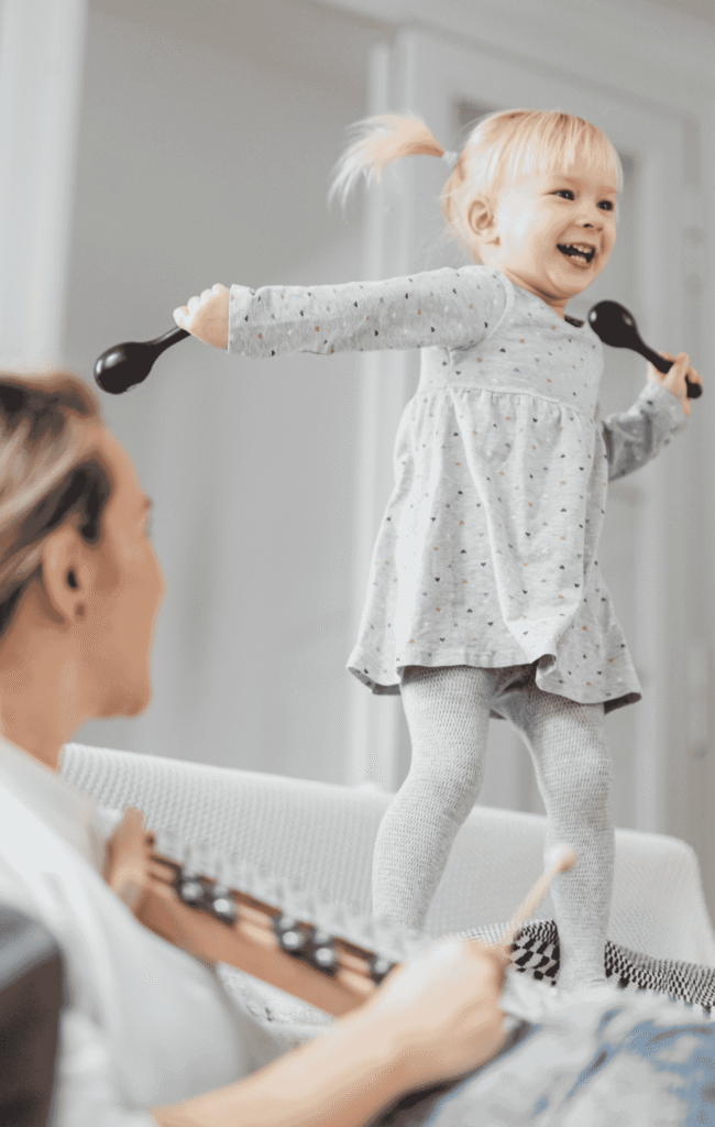 Nanny and child making music on instruments