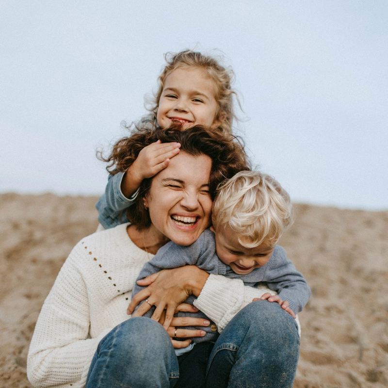 Mother and children playing and laughing