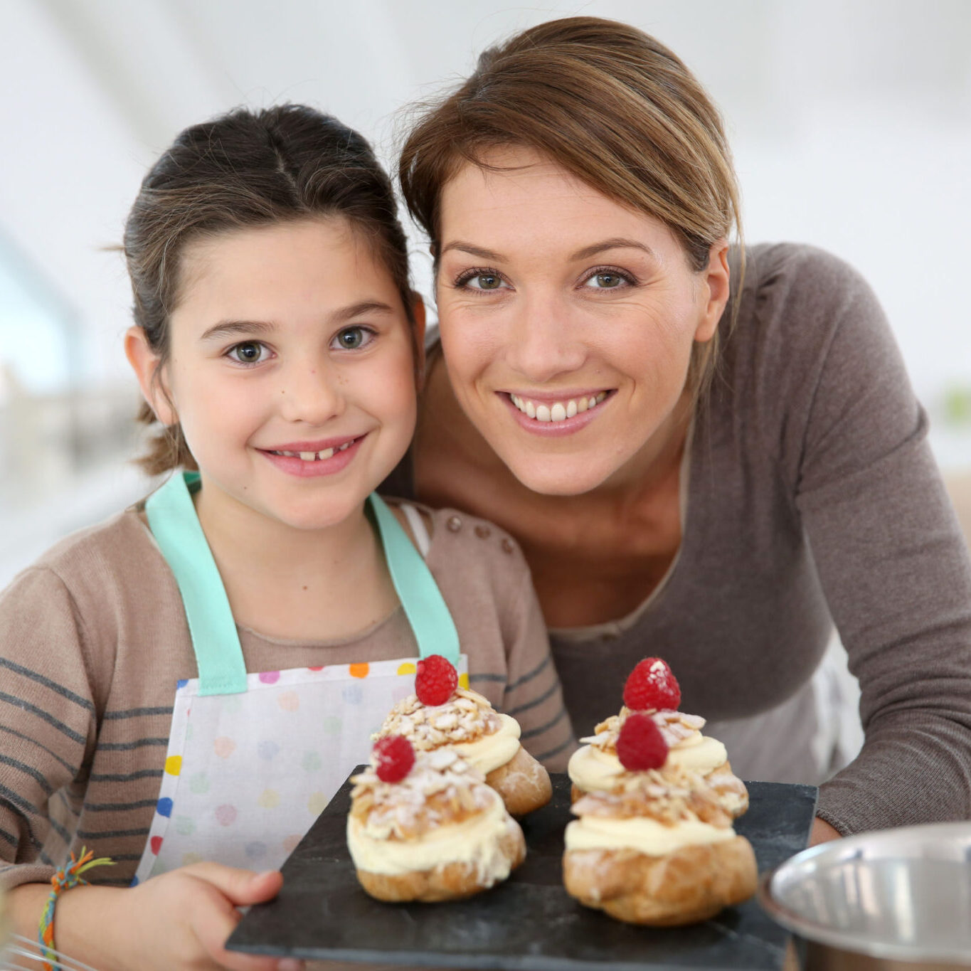 Nanny and girl, brunettes, baking decorative cakes